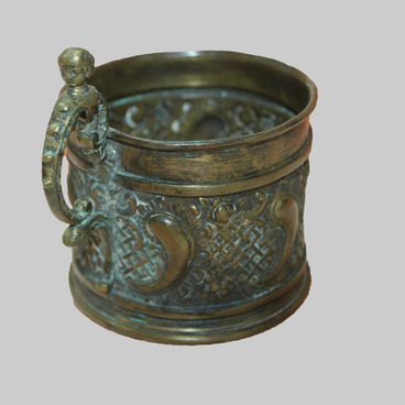 Cup holder with mascaron on the handle