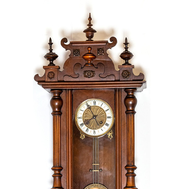 A wall clock in a wooden case