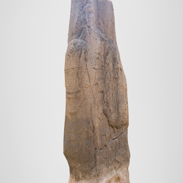 Stone statue with a fantastic mask