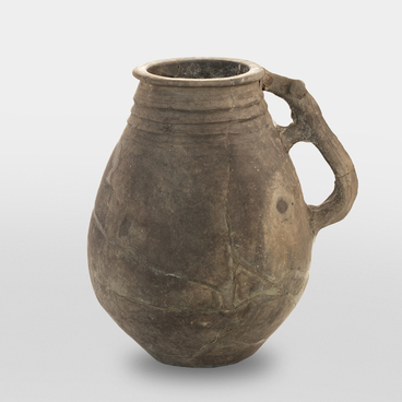 Gray clay jug with a zoomorphic handle